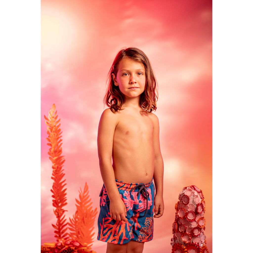 Little boy wearing the Pepita & Me boys swim shorts in Corales Mar print from Tornasol collection
