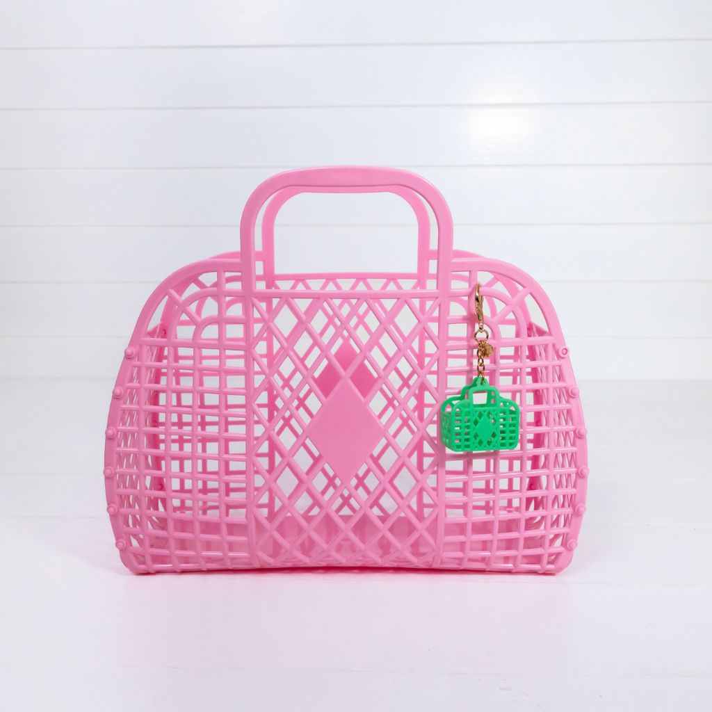 Product shot of the bubblegum pink large retro basket bag from sun jellies with a retro green itty bitty bag charm