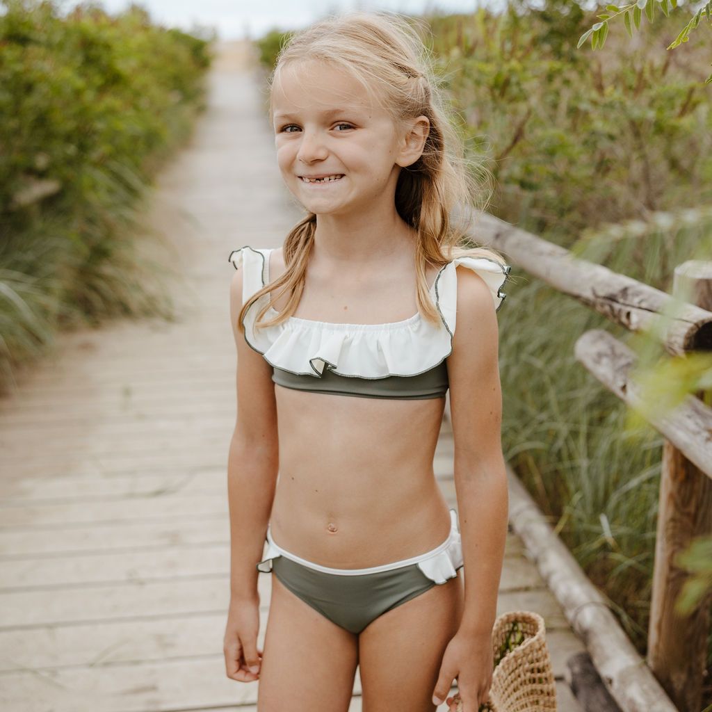 Little girl wearing the Folpetto Elisa bikini in sage green and ivory