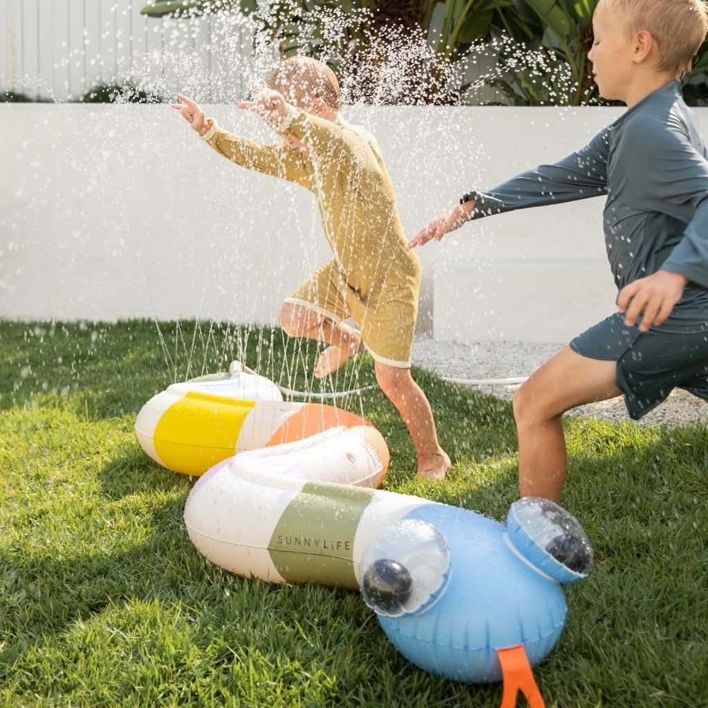 Close up of little boys playing in the Sunnylife Inflatable Garden Sprinkler Into The Wild