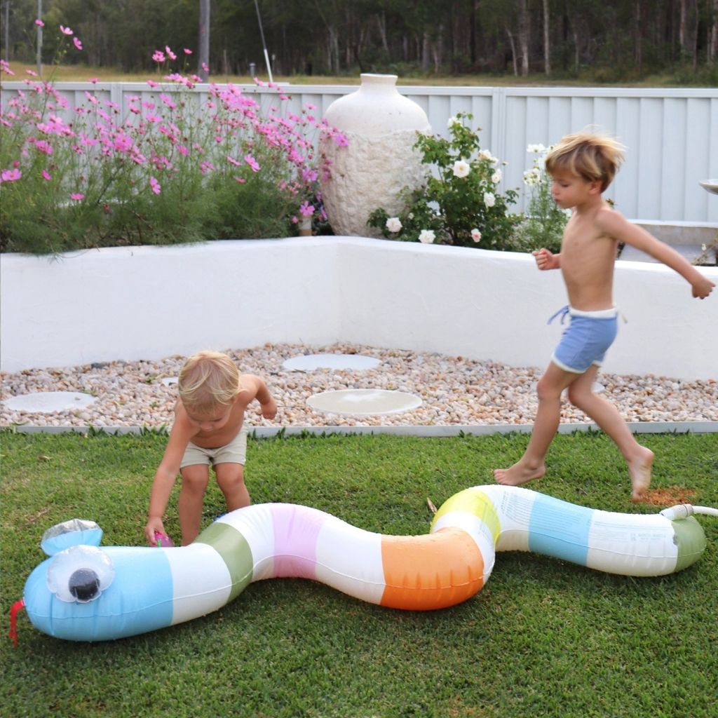 Little boys playing in the garden with the Sunnylife Inflatable Garden Sprinkler Into The Wild