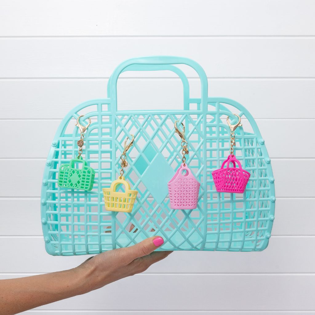 Product shot of a seafoam large retro basket bag from sun jellies with itty bitty bag charms