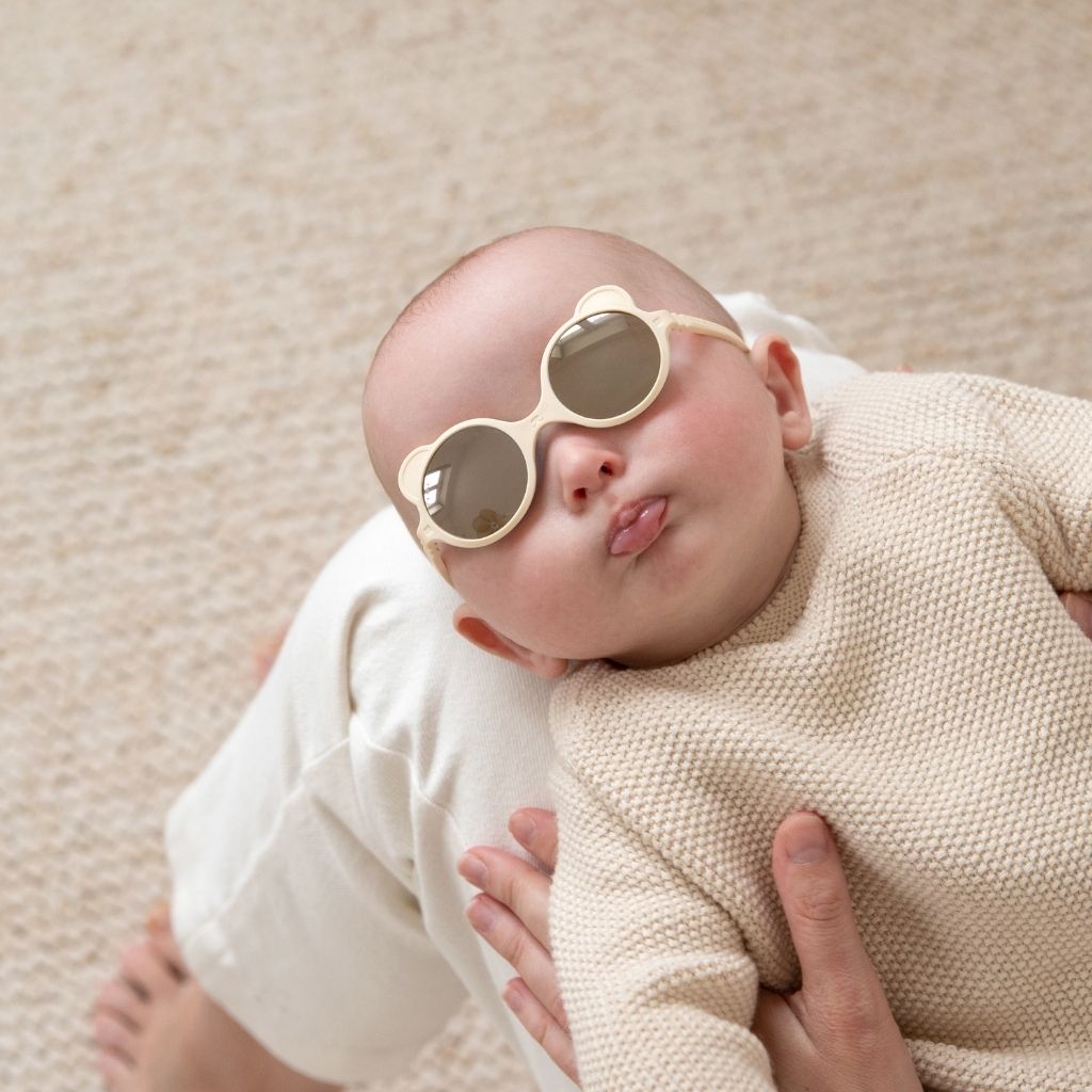 Baby wearing Ki et La Ours'on baby sunglasses in cream
