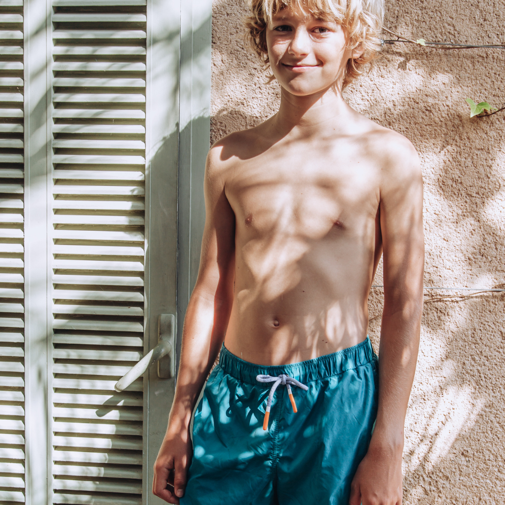 Boy posing in Lison Paris Boys Capri shorts in tennis green