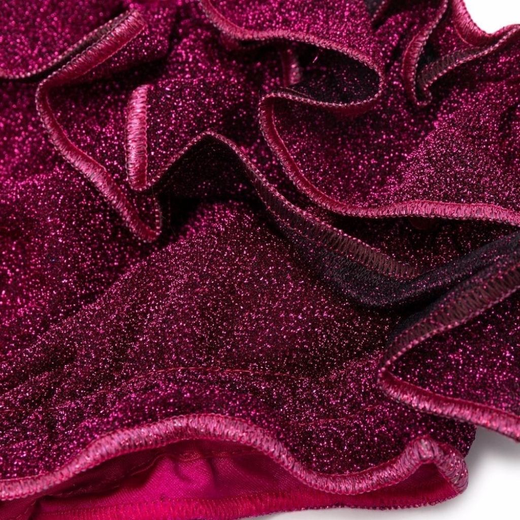 Close up of fabric and ruffle detailing on Oseree Kids Osemini Lumiere metallic ruffle girls bikini in fuchsia pink