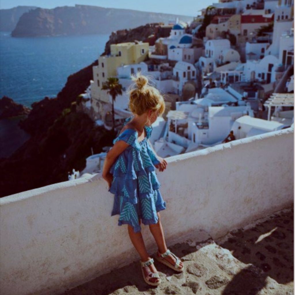 Little girl wearing the Devotion Twins Stars Eliza dress in shades of blue