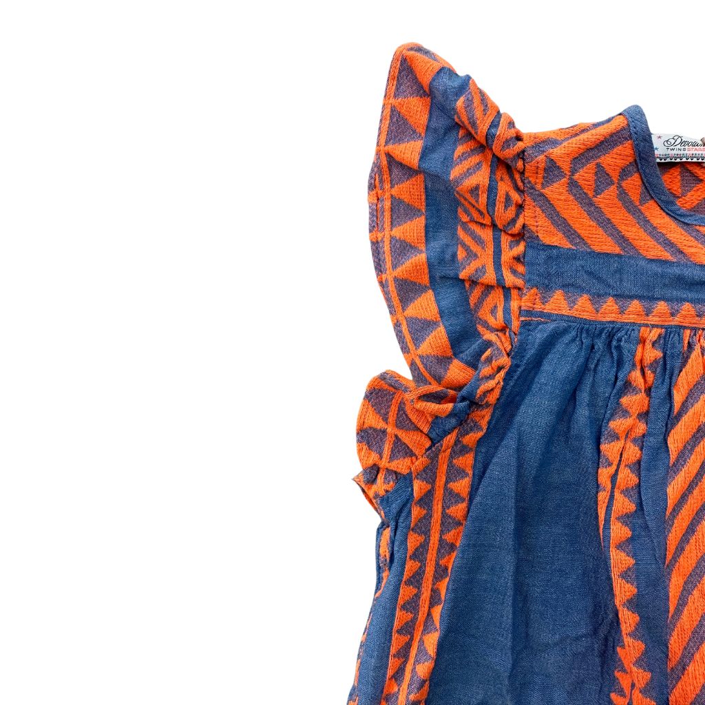 Close up of the fabric on the Devotion Twins Stars Violeta Blouse Top in Orange and Blue
