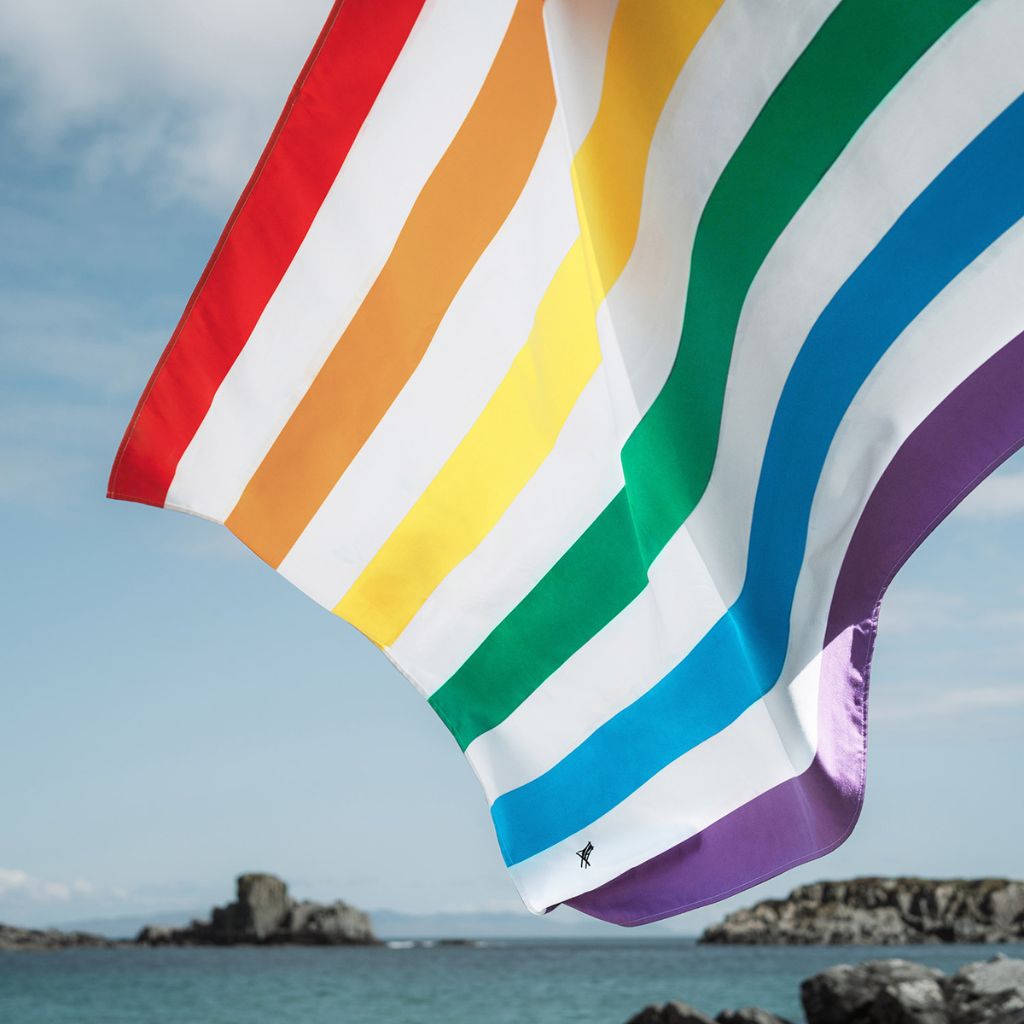 Close up shot of Dock and Bay Striped Summer Beach towel in Rainbow Skies