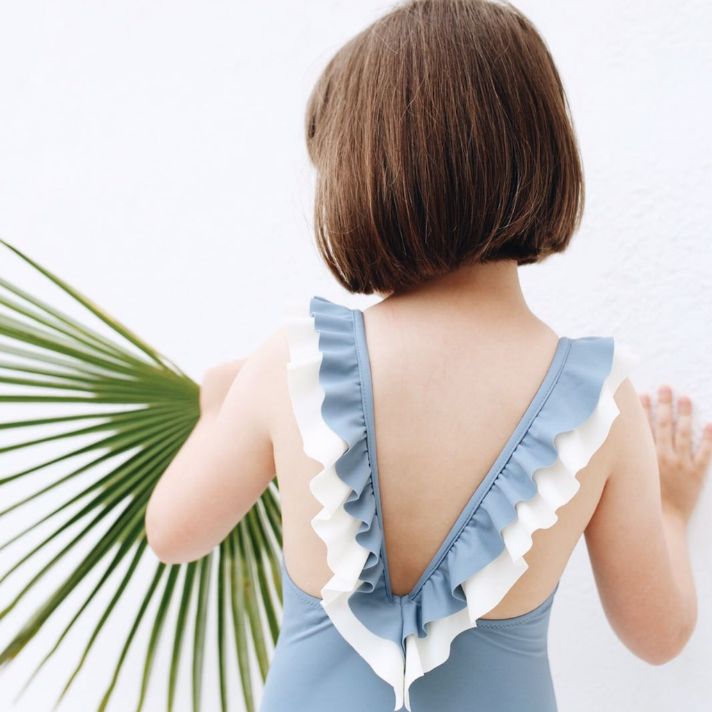 Folpetto penelope swimsuit for girls in dusty blue with white ruffle