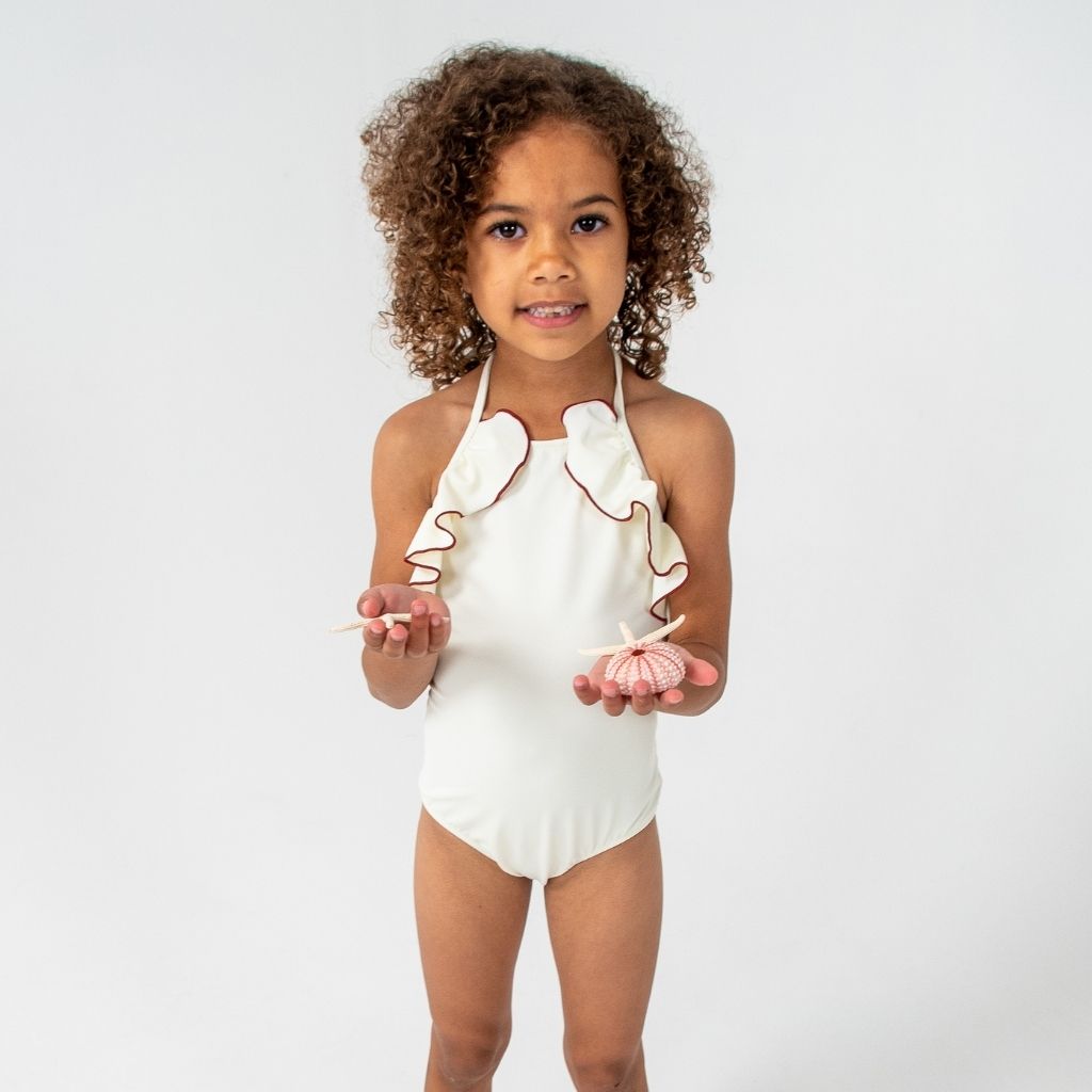 Little girl wearing Linda one piece swimsuit from Folpetto in Ivory and Terracotta