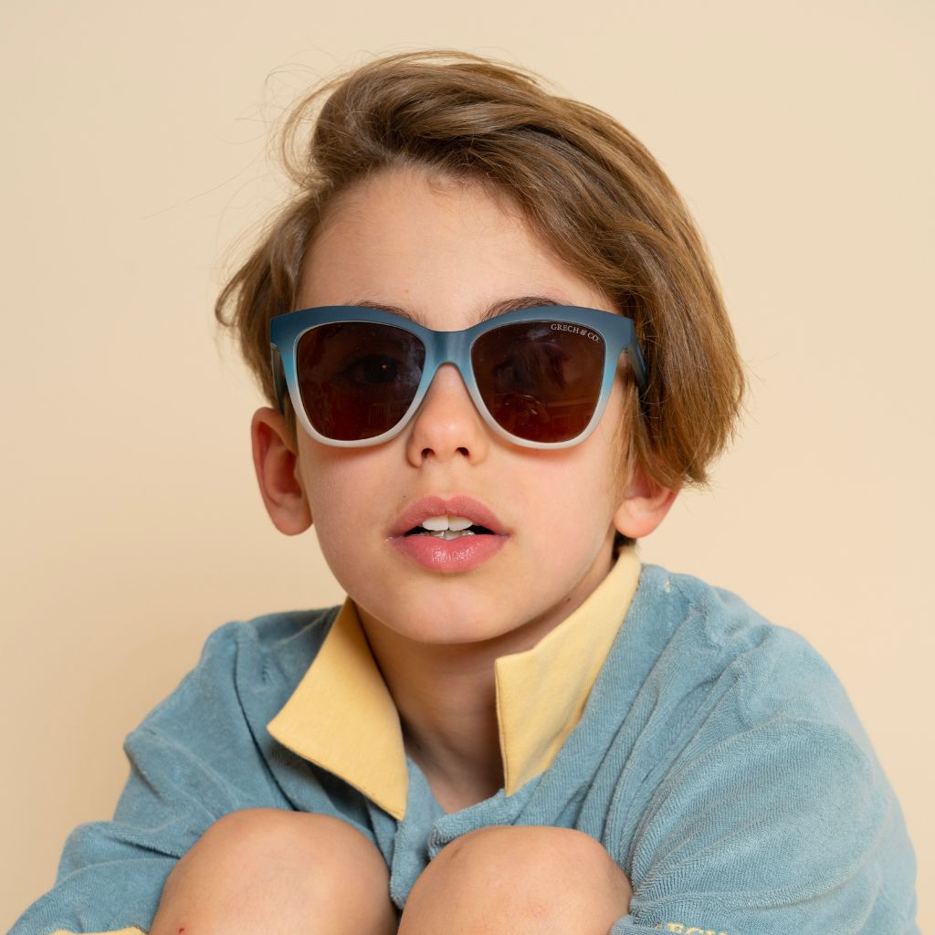 Boy wearing Grech & Co Iconic Wayfarer with polarised lenses for children in desert teal