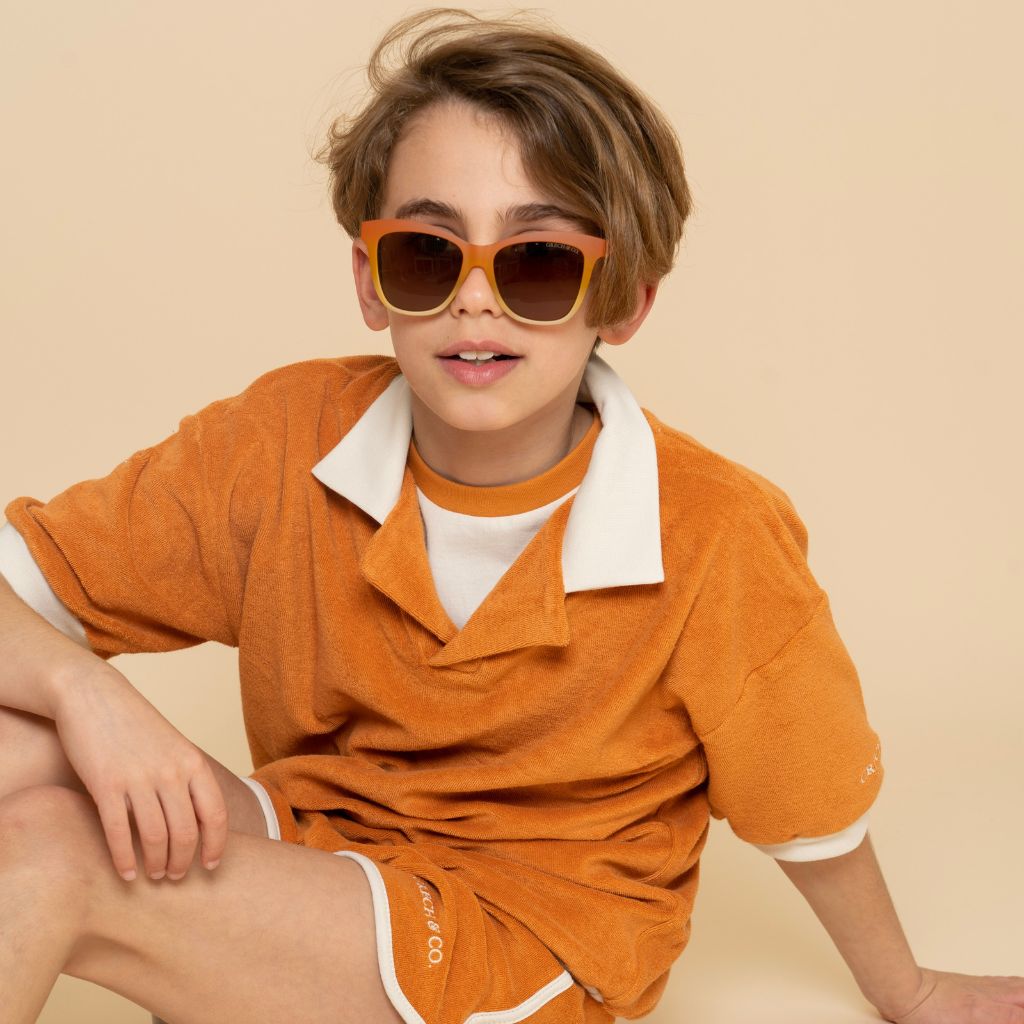 Boy wearing Grech & Co Iconic Wayfarer with polarised lenses for children in Sienna ombre