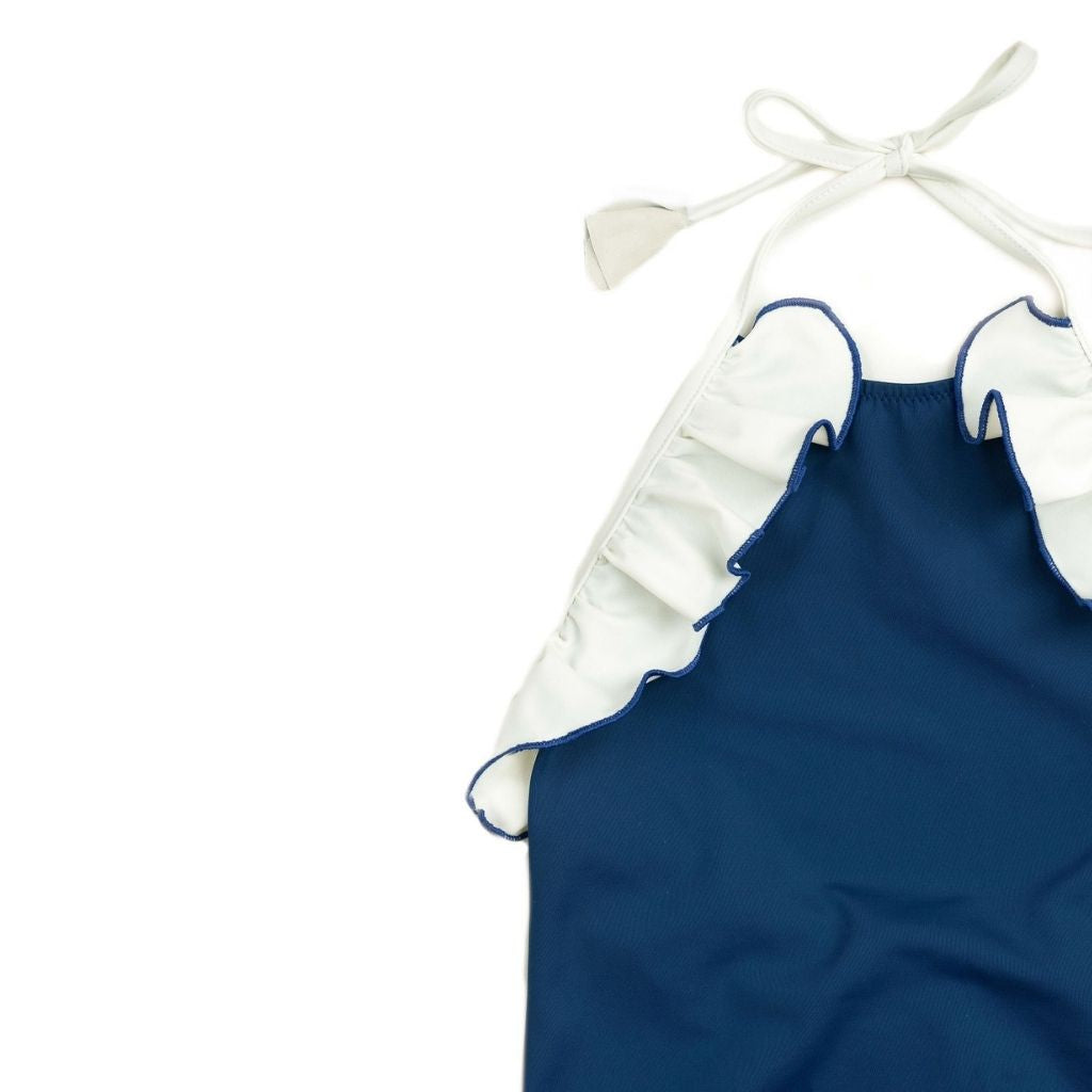 Close up of ruffle detail on Linda one piece swimsuit from Folpetto in Night Blue and Ivory