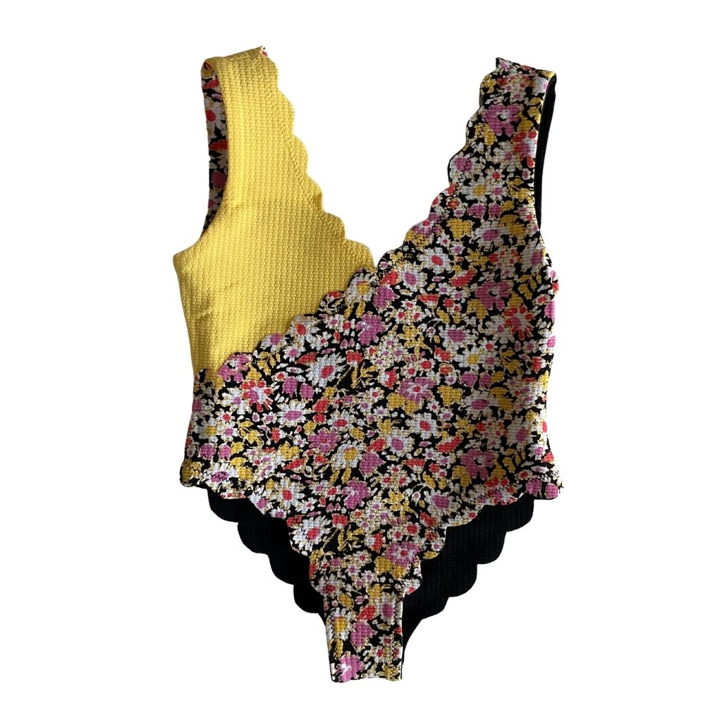 Reverse front view of Marysia Bumby Canyon Point reversible swimsuit in black and blossom flower and yellow and blossom flower print