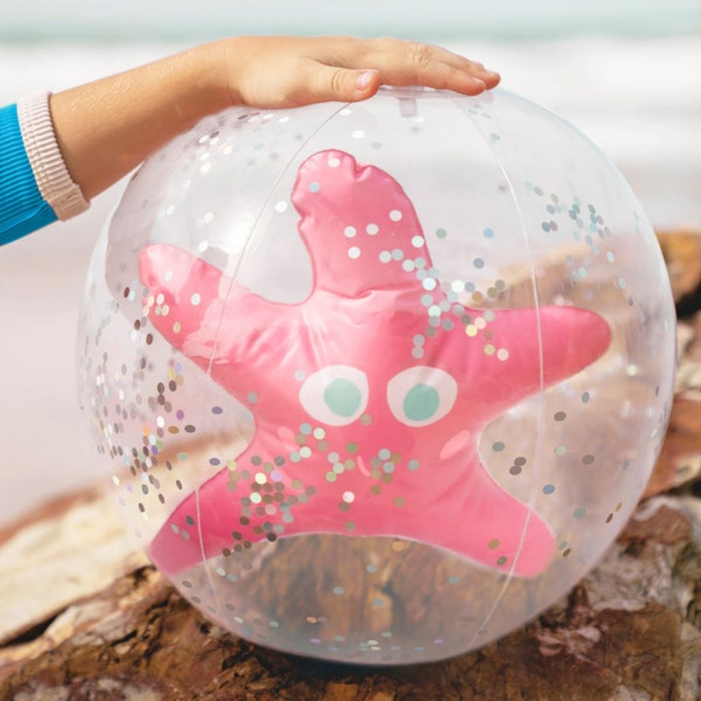 Child holding Sunnylife 3D inflatable beach ball in Ocean Treasure Rose