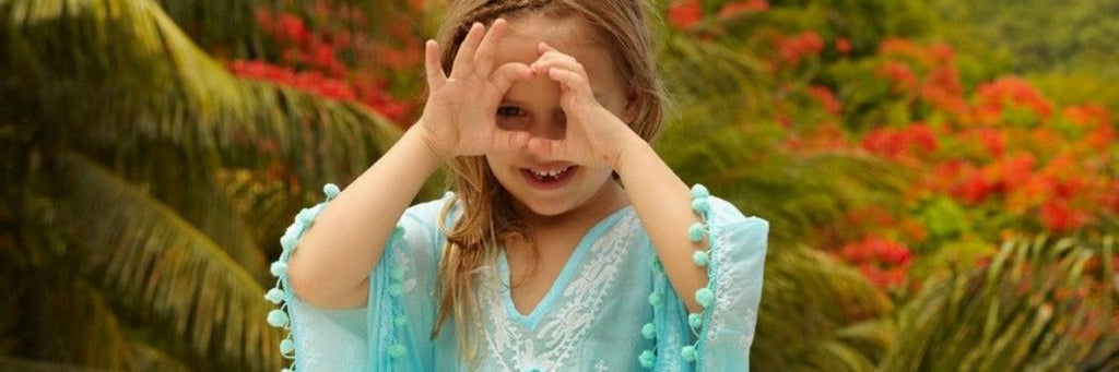 Little girl wearing Sharize cover-up in cornflower blue from Melissa Odabash kids