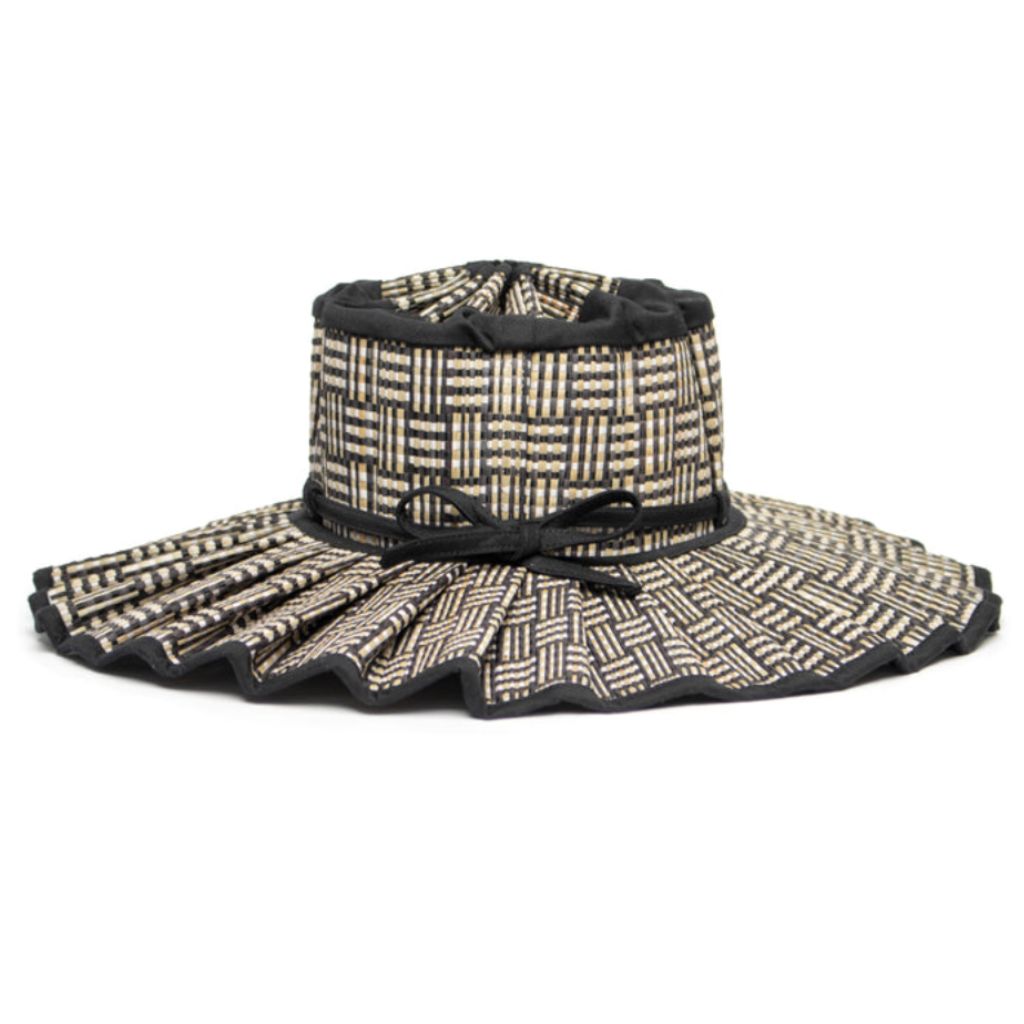Product shot of a side view of the Lorna Murray Black Bamboo Island Capri Child Hat