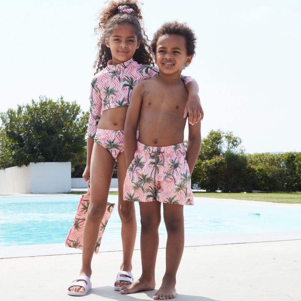 Little boy with girl both wearing the Marie Raxevsky Cuba print swim shorts and bikini
