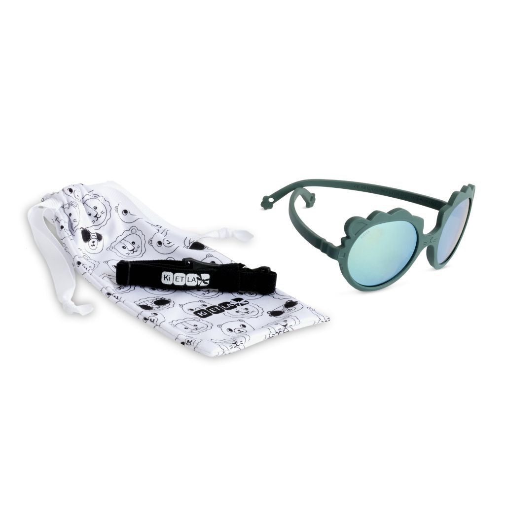 Product shot of the dust bag and strap of the Ki et La Lion Baby Sunglasses in green