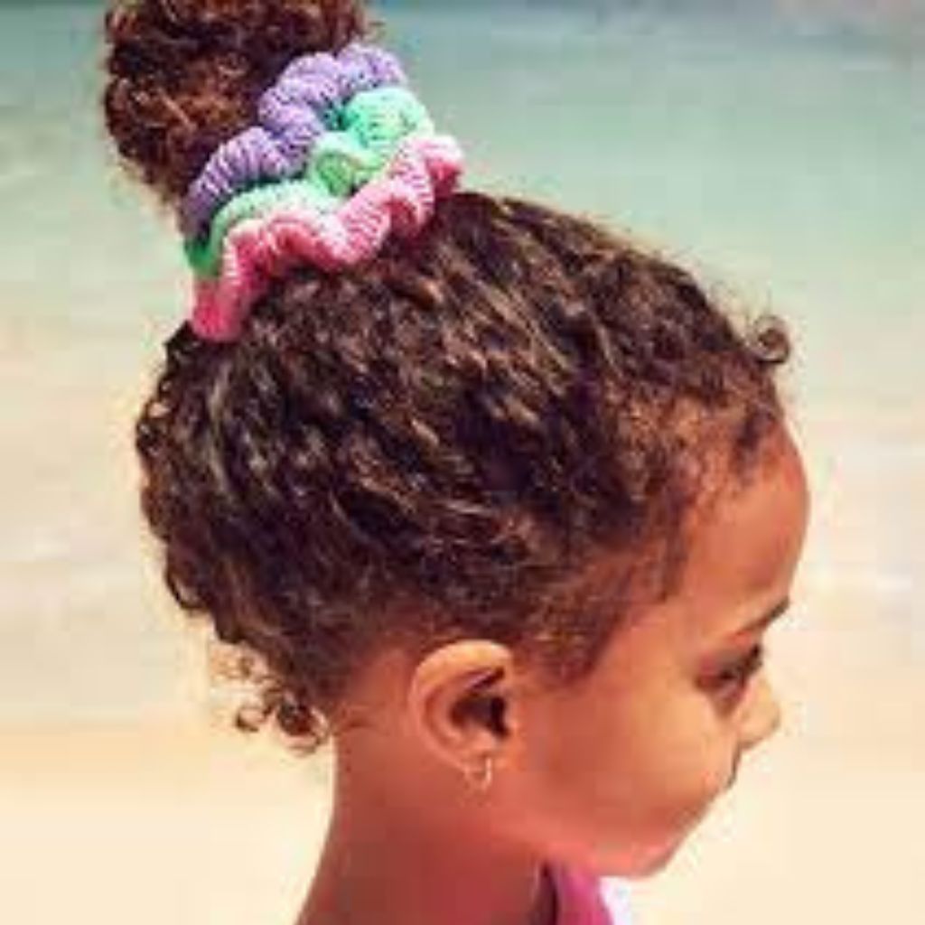 Little girl wearing the Hunza G pack of 3 kids hair scrunchies in bubblegum, lilac and lime