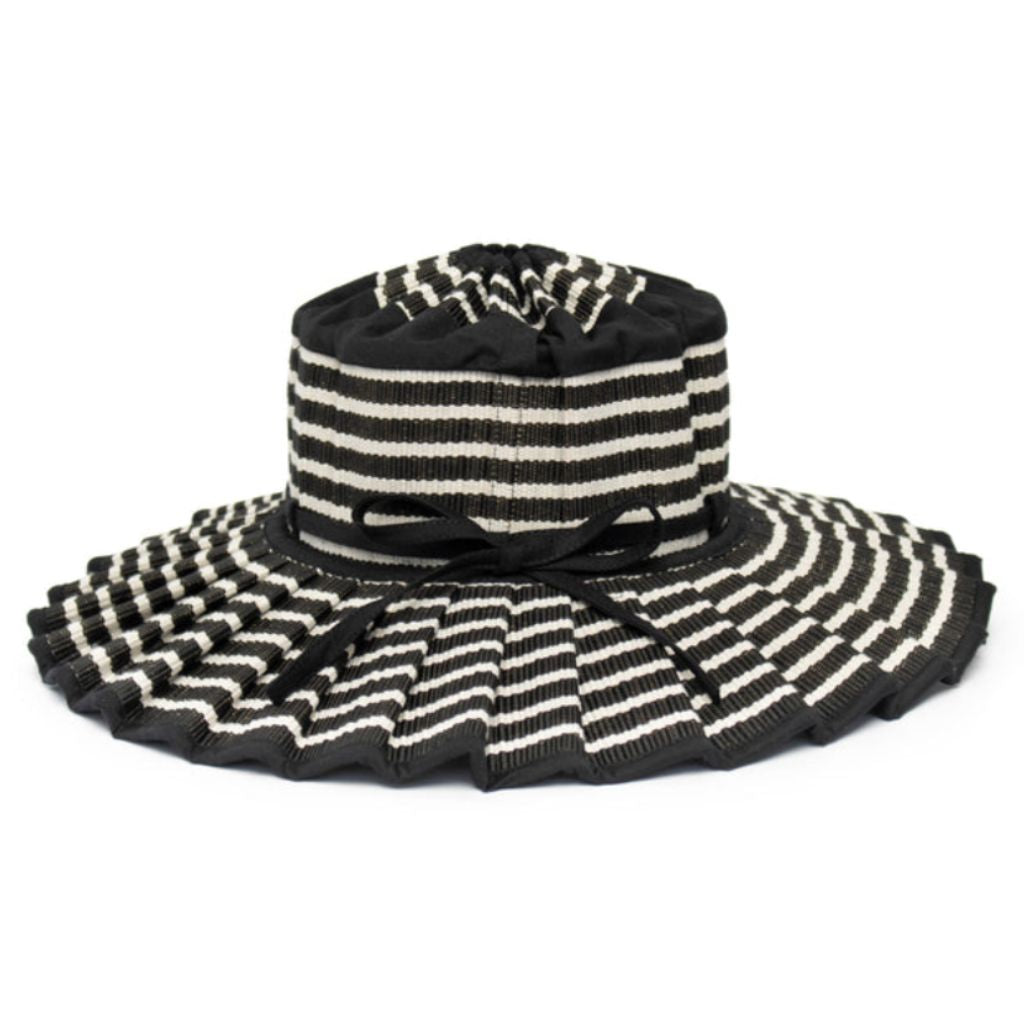 Product shot of a side view of the Malta Island Capri Child's Sun Hat from Lorna Murray in black and white