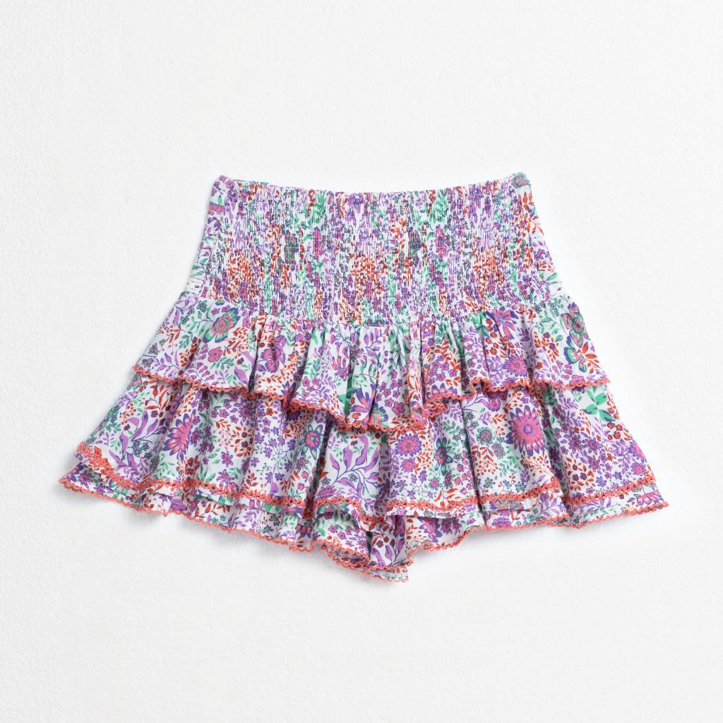 Product shot of the back of the Alizee Mini Skirt from Poupette St Barth Kids in White Lavender Nature print