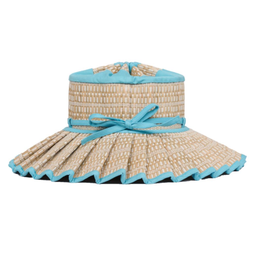 Product shot of a side view of the Narrabeen Island Capri Child's Sun Hat from Lorna Murray featuring sky blue trimming
