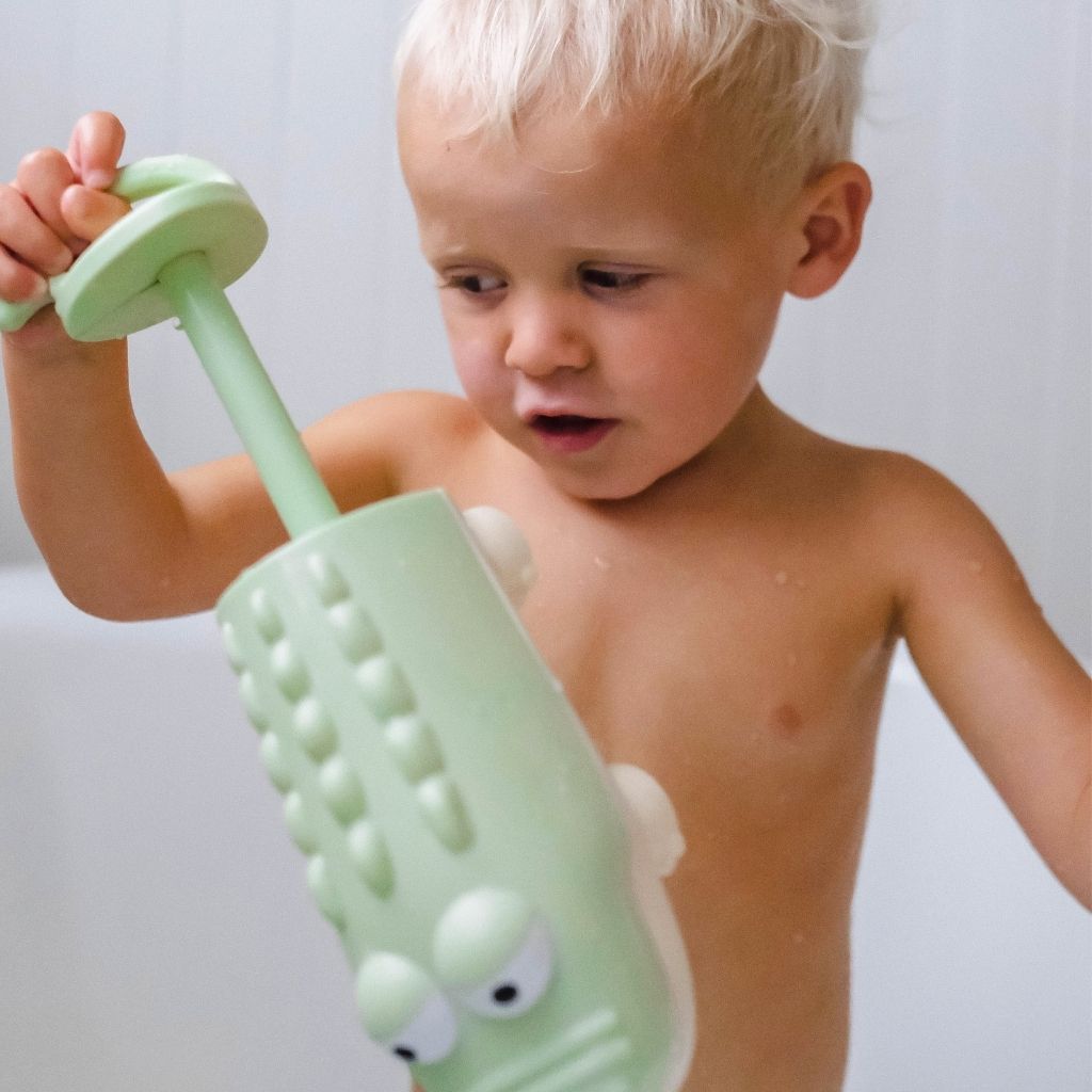 Little boy playing in the bath with the Sunnylife Pastel Green Crocodile Water Squirter