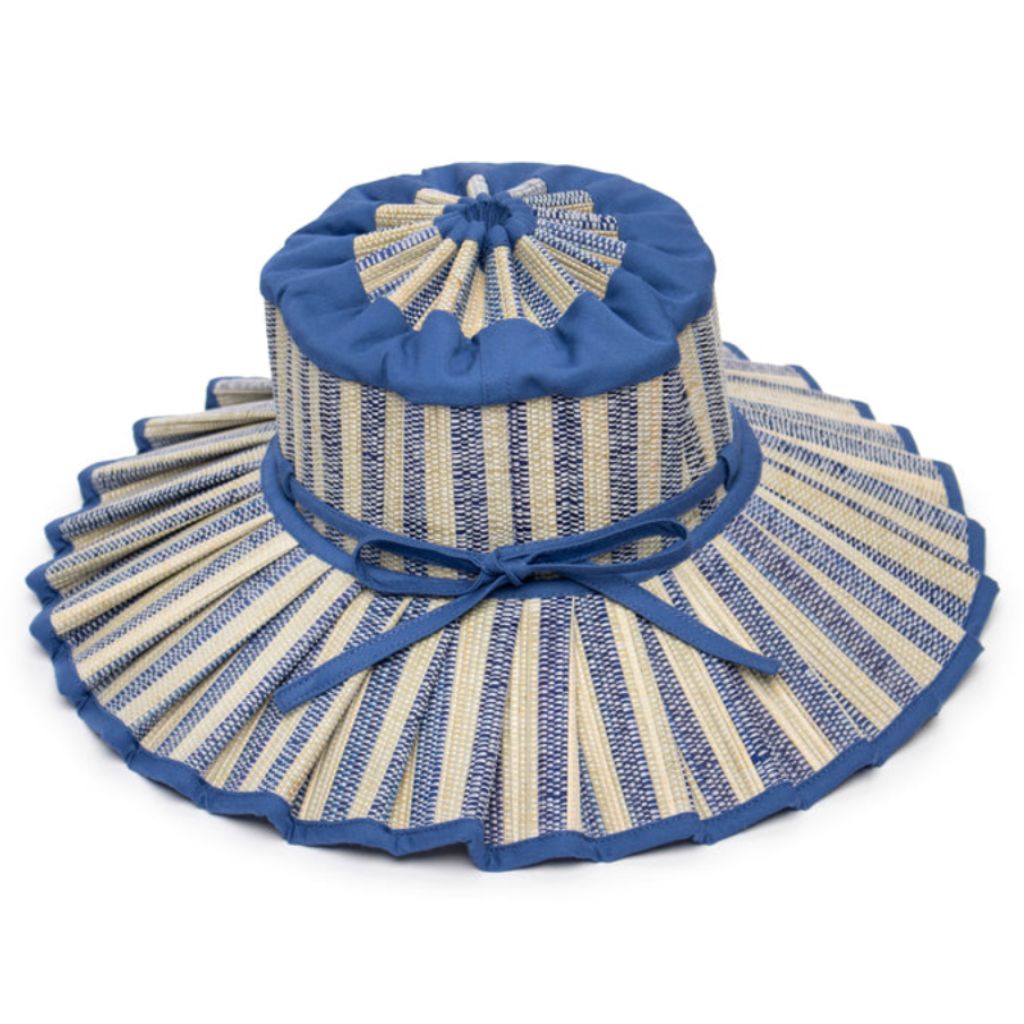 Product shot of a tilted side view of the Valletta Island Capri Child's Sun Hat from Lorna Murray in Royal Blue