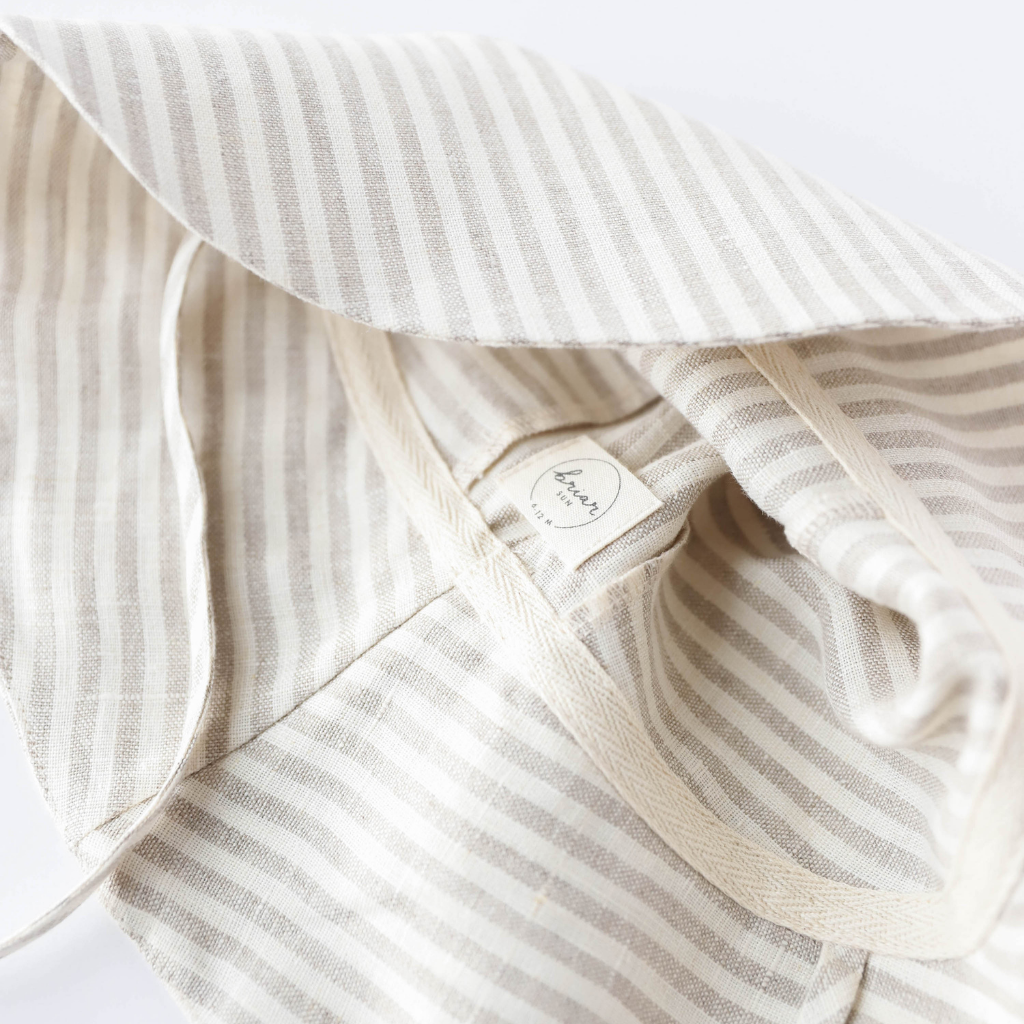 Close up product shot of Briar Baby sun hat in beige and grey Harbor Stripe