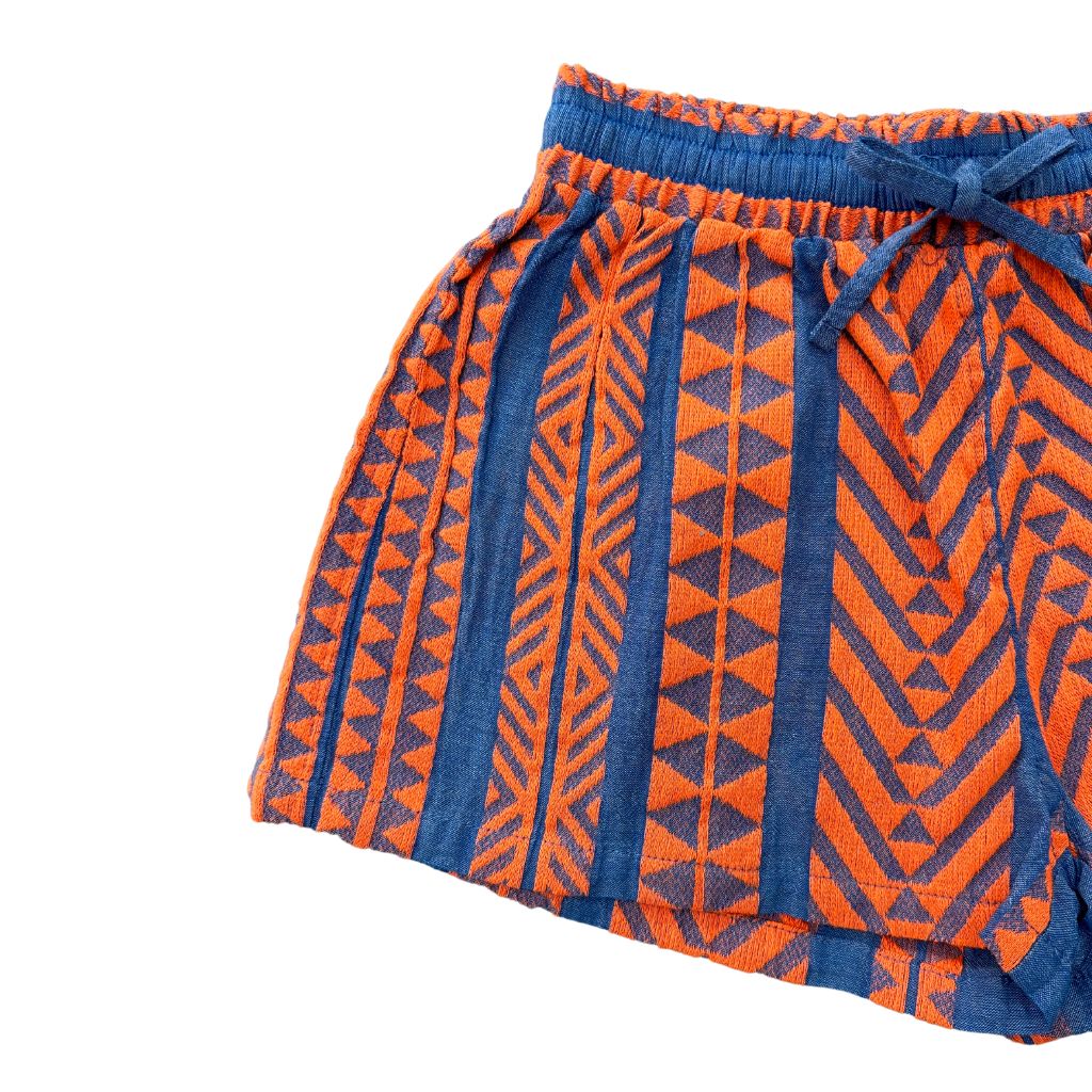 Close up of the Devotion Twins Stars Evita shorts in orange and blue