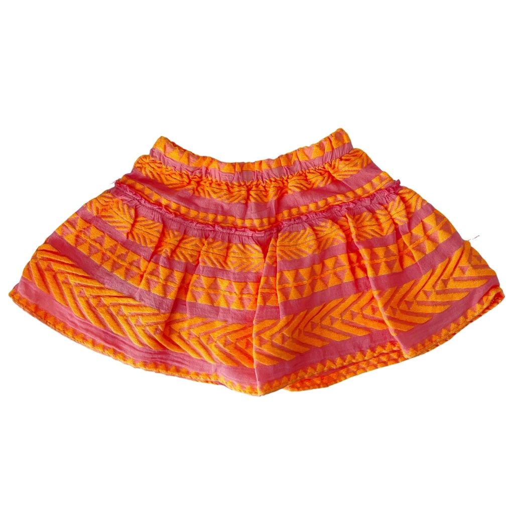 The Snow White skirt with concealed shorts in neon orange and neon pink from the children's line of Greek resort wear brand, Devotion Twins