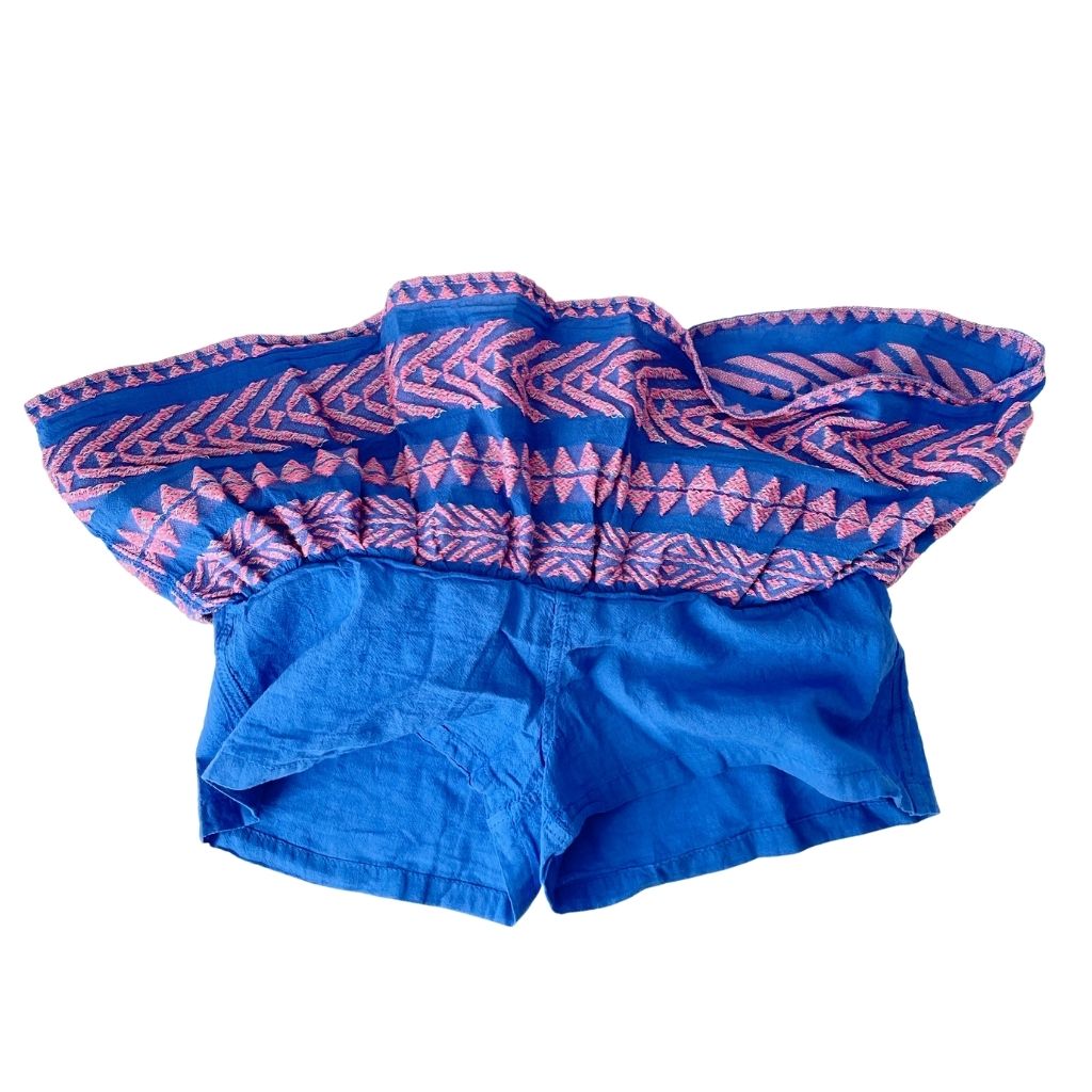 The concealed shorts inside the Snow White skirt in neon pink and bright blue from the children's line of Greek resort wear brand, Devotion Twins