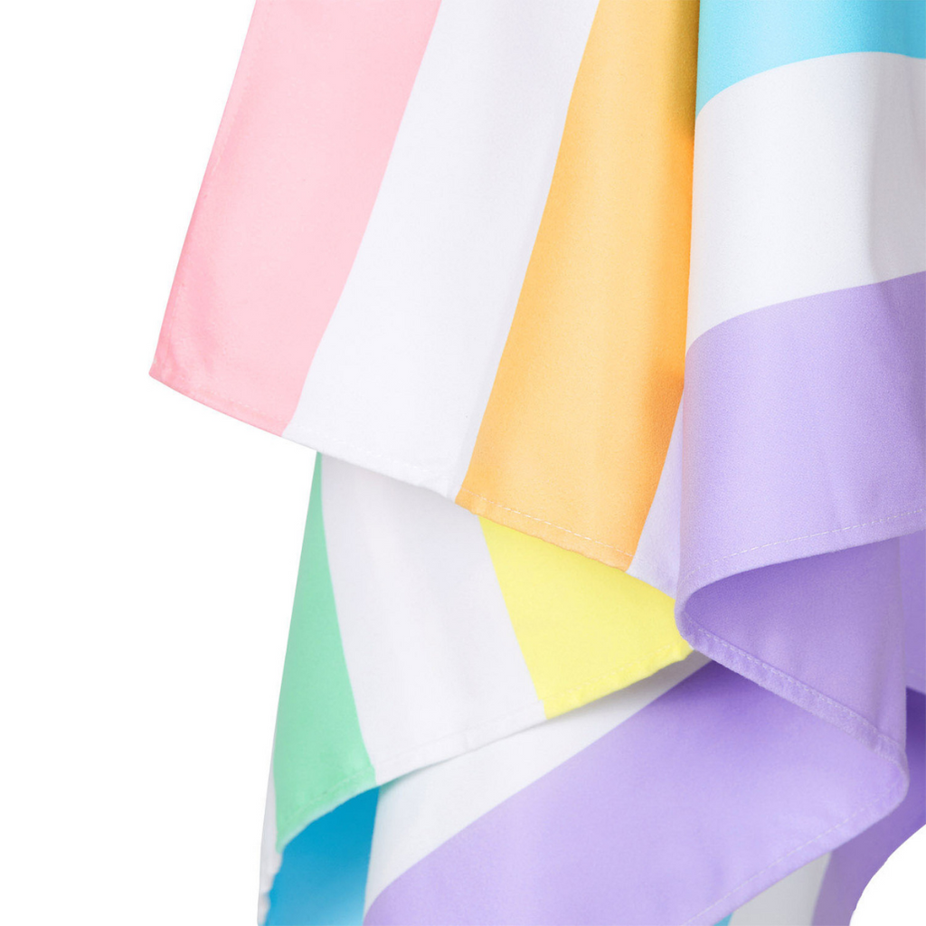 Close up of Dock & Bay Summer Beach Towel in Unicorn Waves featuring pastel hued stripes in purples, blue, green, yellow, orange and pink