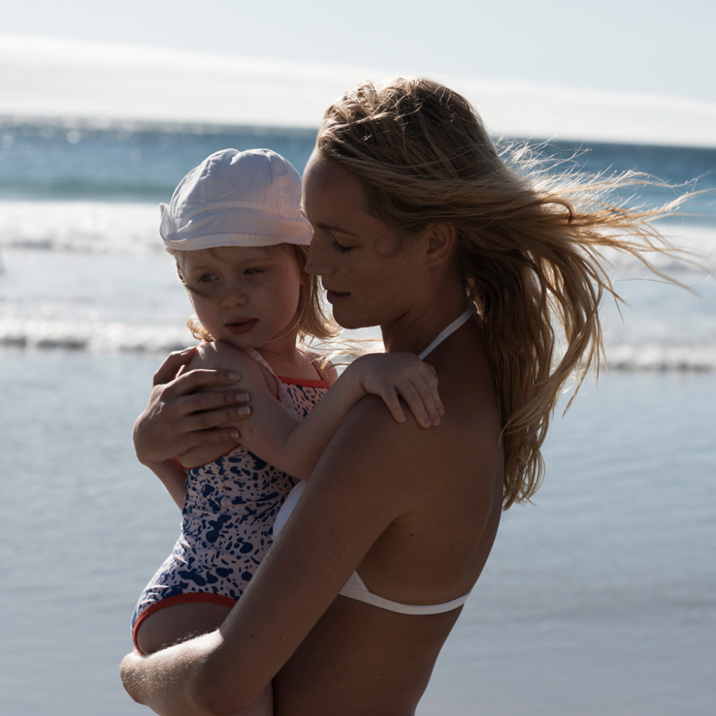 Mummy and daughter on the beach wearing Evy Technology sunscreen mousse SPF 50