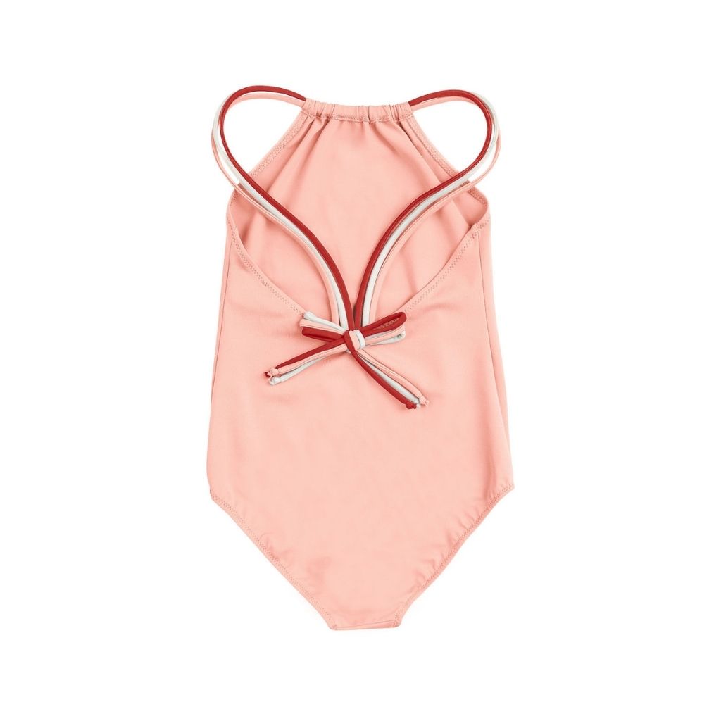 Back view of the Folpetto Frida one piece swimsuit in peach pink, terracotta and ivory