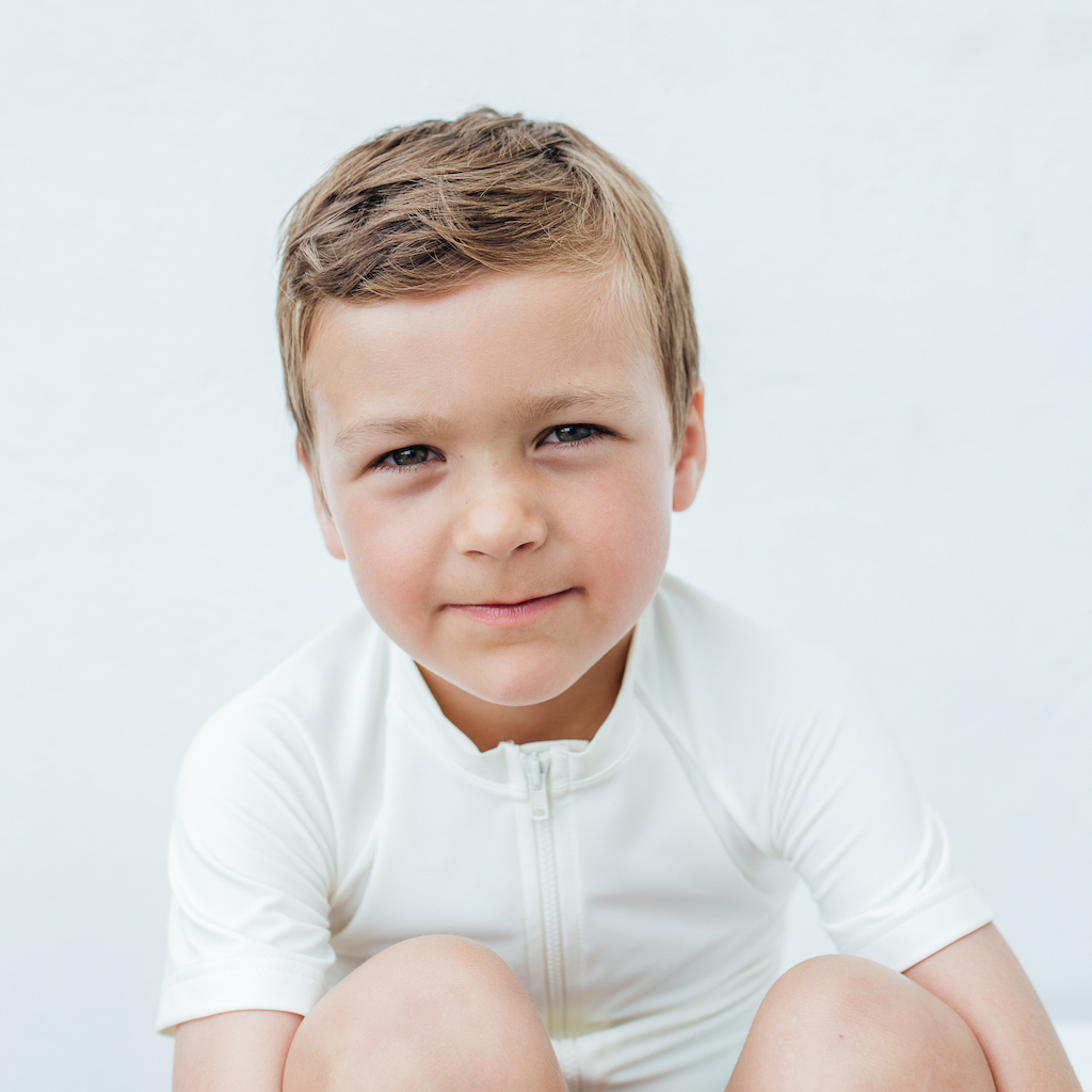 Little boy wearing Folpetto Alex rashvest in white