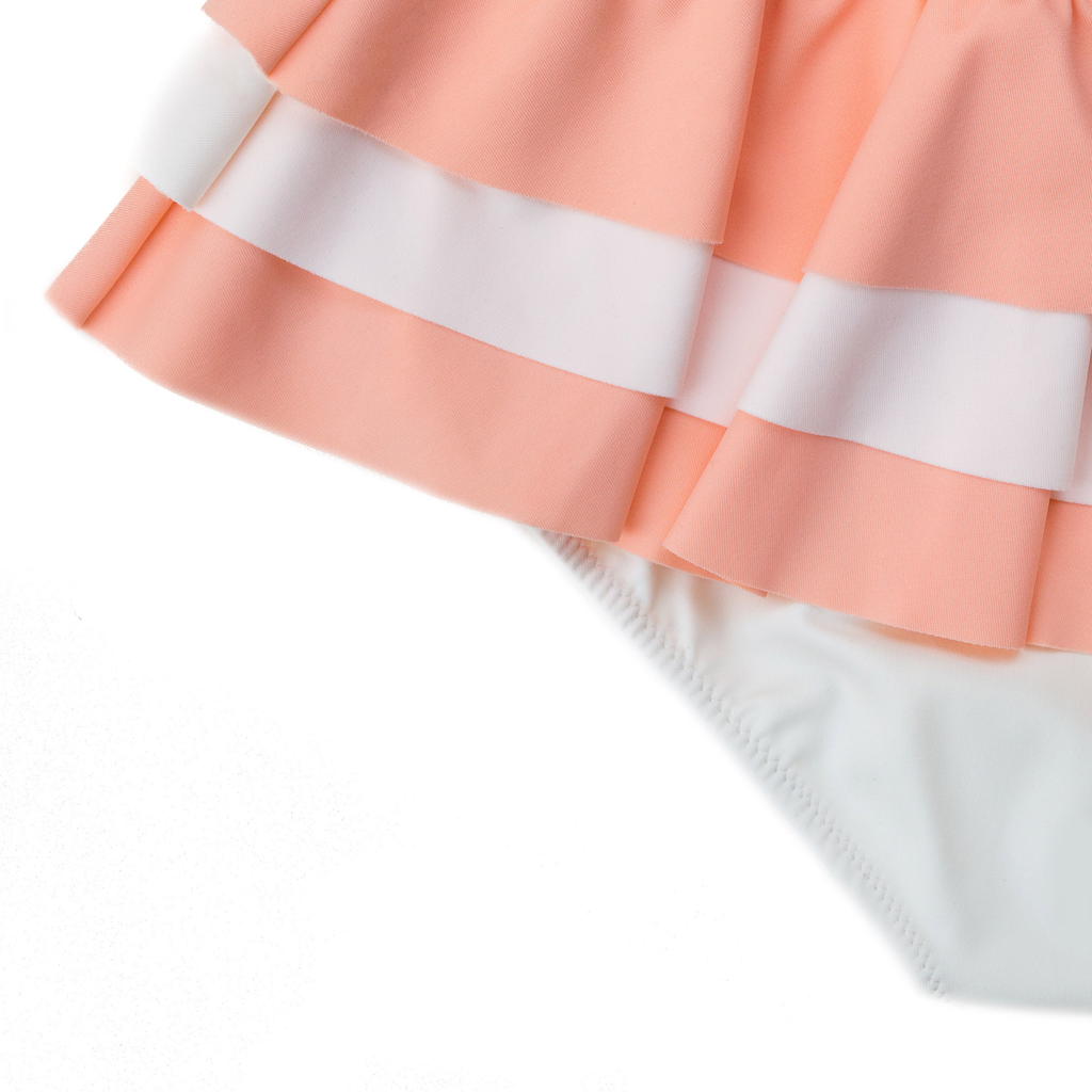 Close up of Folpetto Amelia swimsuit in peach pink