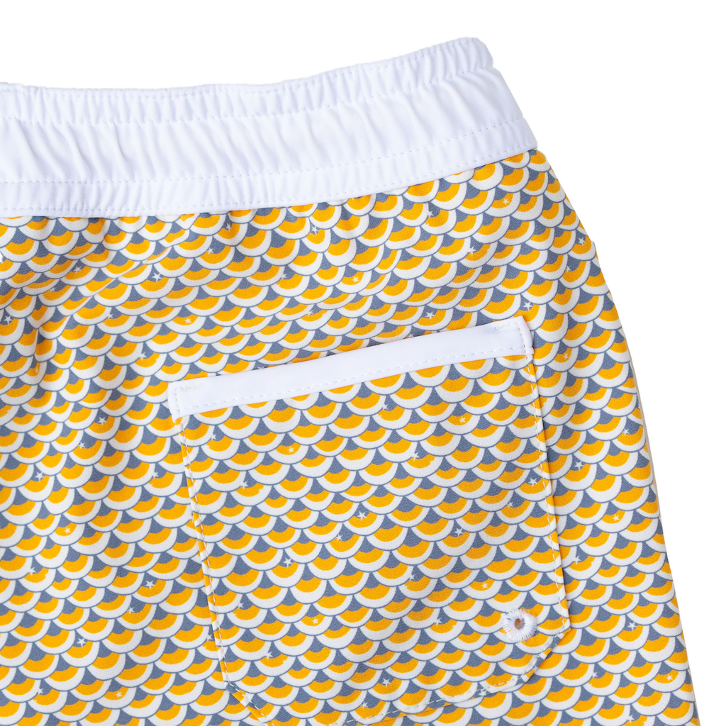 Folpetto Tommaso swim shorts for boys in mango yellow and pebble grey scales print