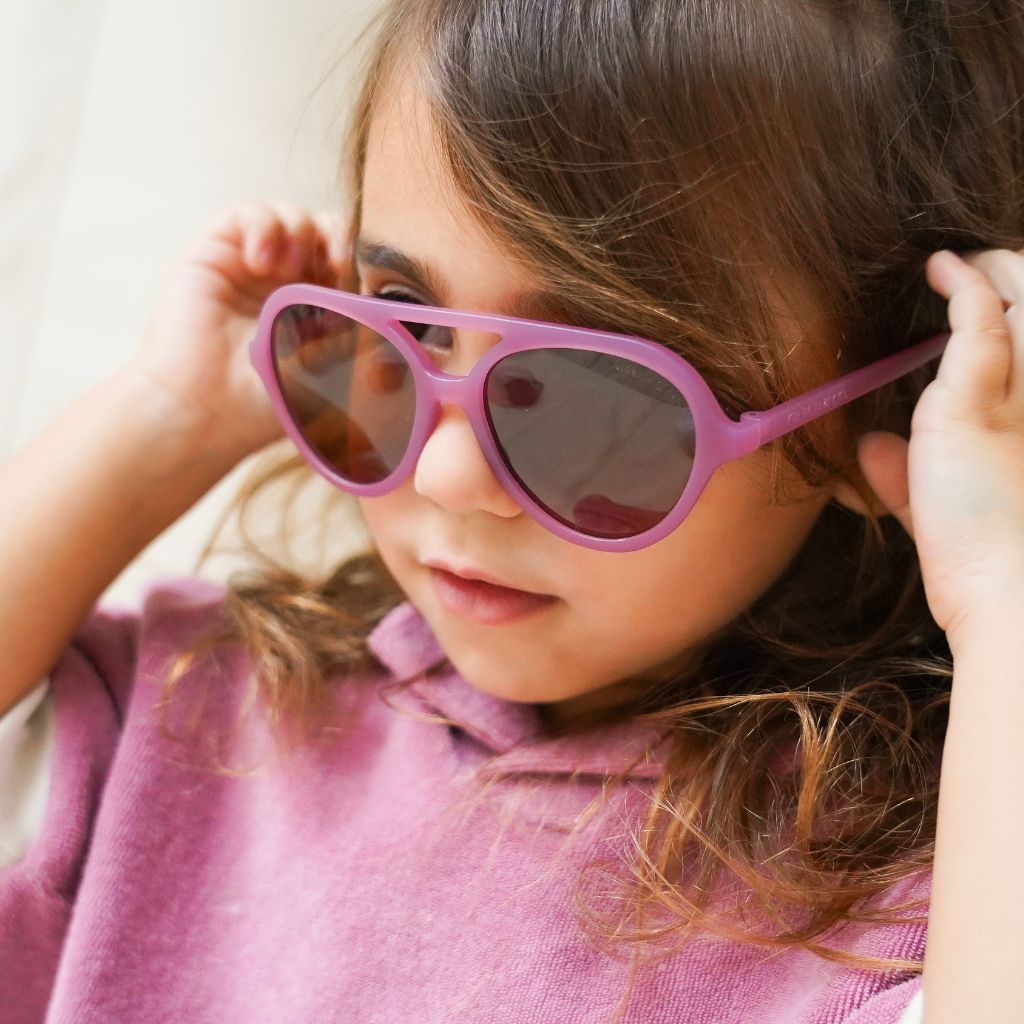 Little girl wearing Grech and Co Aviator Polarised Sunglasses for babies, toddlers and children in mauve rose
