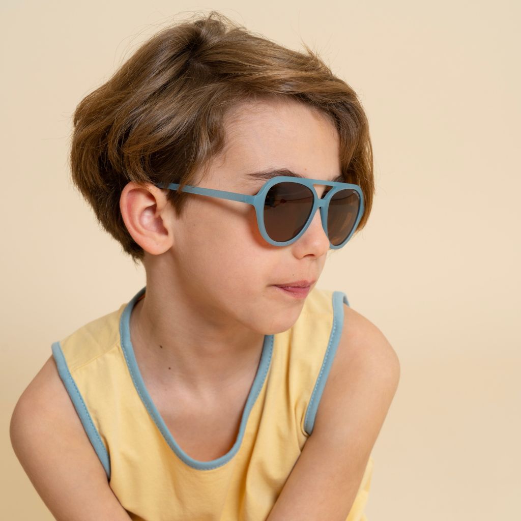Side shot of boy wearing Grech and Co Aviator Polarised Sunglasses for babies, toddlers and children in sky blue