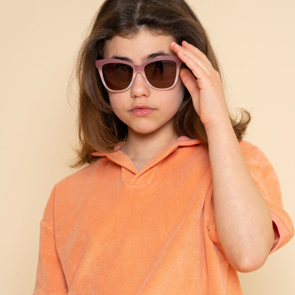 Girl wearing Grech & Co Iconic Wayfarer with polarised lenses for children in mauve rose ombre