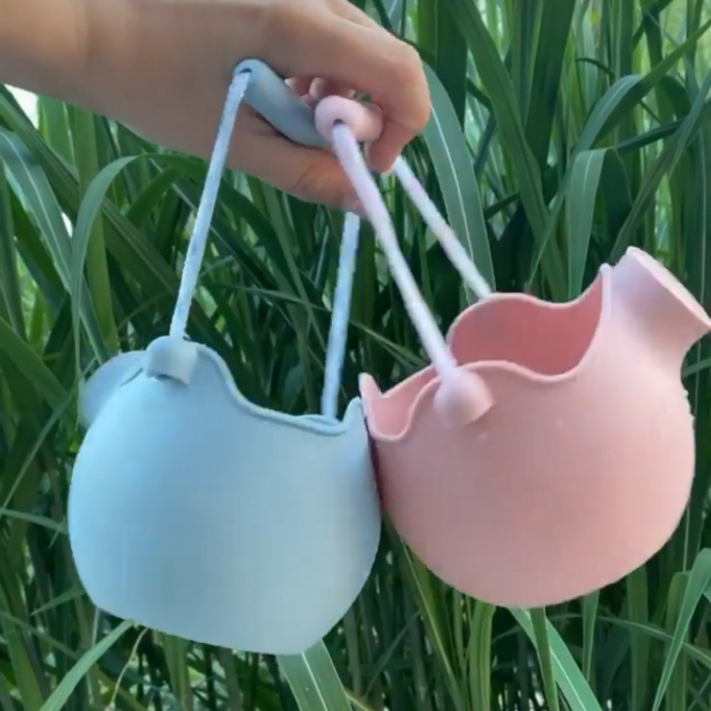Scrunch silicone watering cans in duck egg blue and old rose