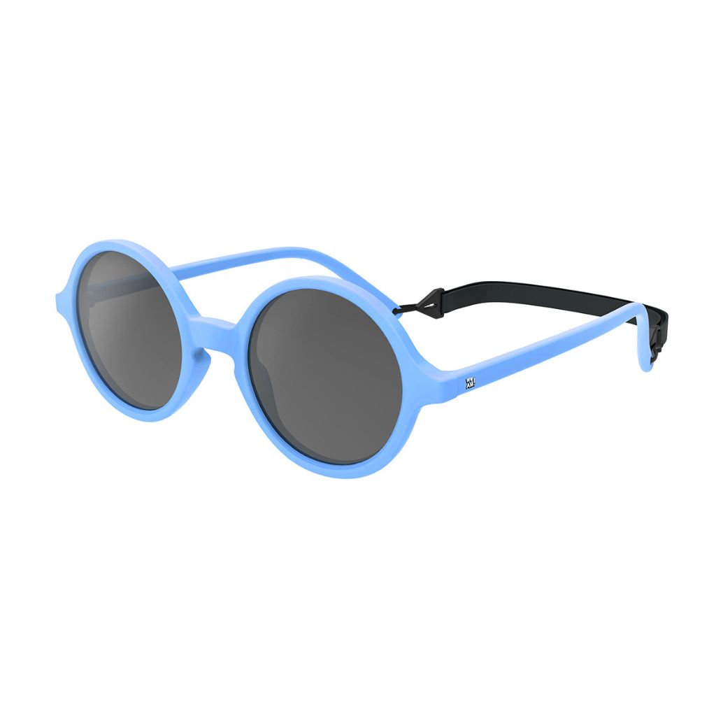 Side view of Ki et La Woam round lens children's sunglasses in bright blue with strap
