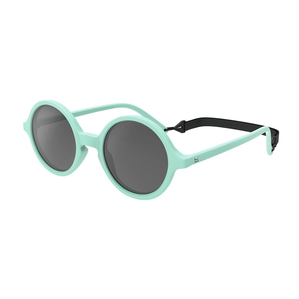Side view of Ki et La Woam round lens children's sunglasses in bright green including strap