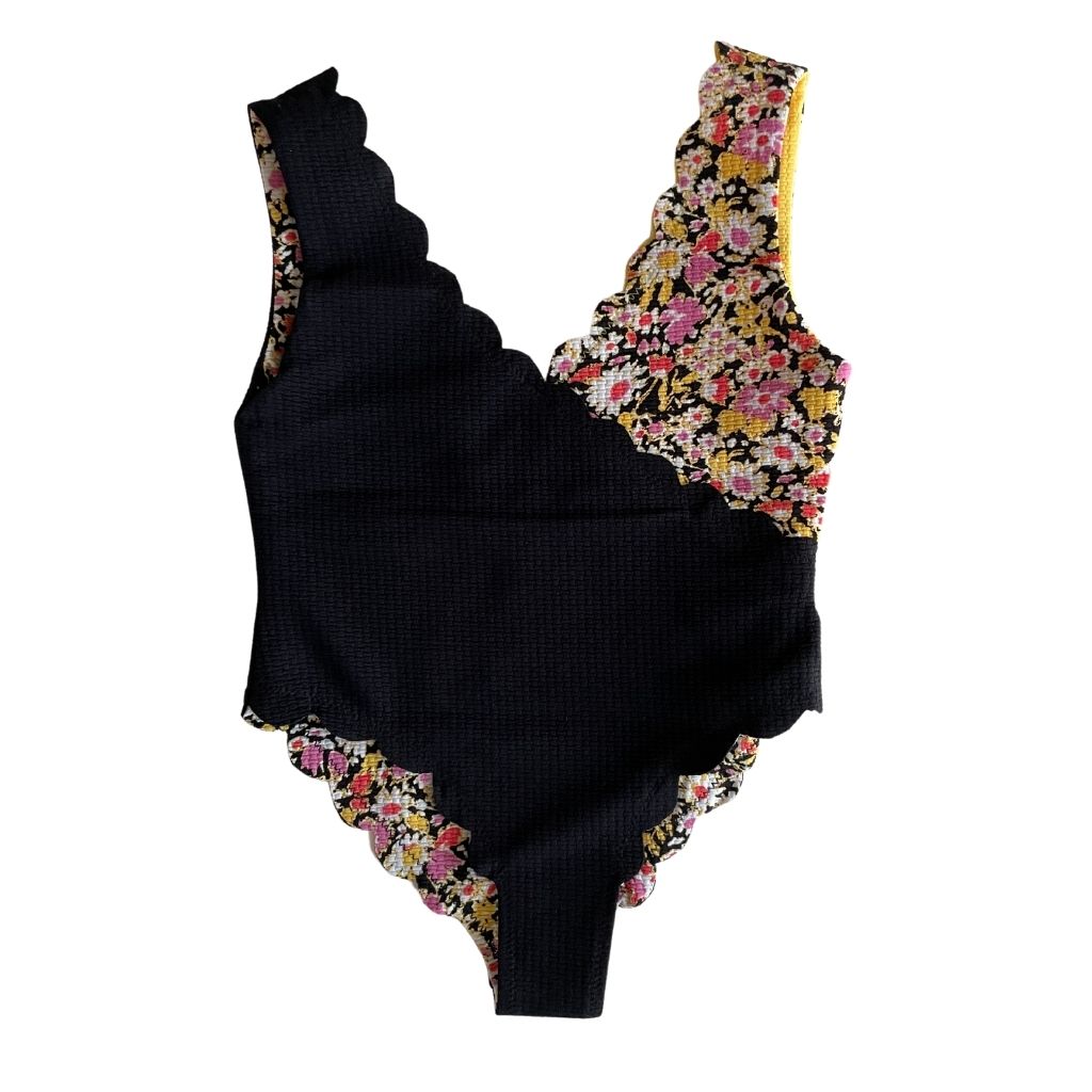 Back view of Marysia Bumby Canyon Point reversible swimsuit in black and blossom flower and yellow and blossom flower print
