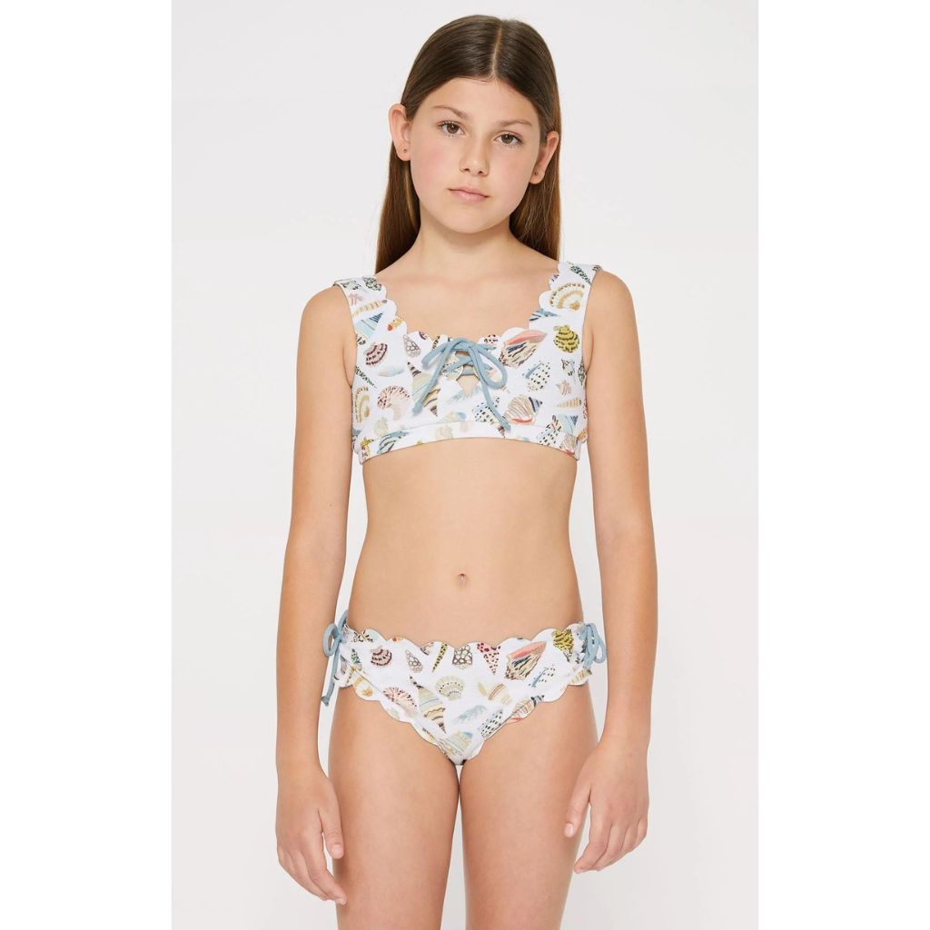 Little girl wearing the Marysia Bumby Palm Springs Lace Up Bikini Top in Coconut Shell Print and Crystalline