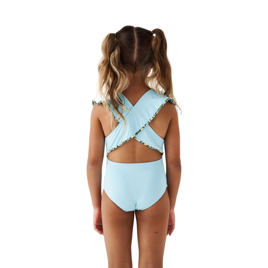 Little girl's back view wearing Marysia Bumby Piana swimsuit in Horizon blue