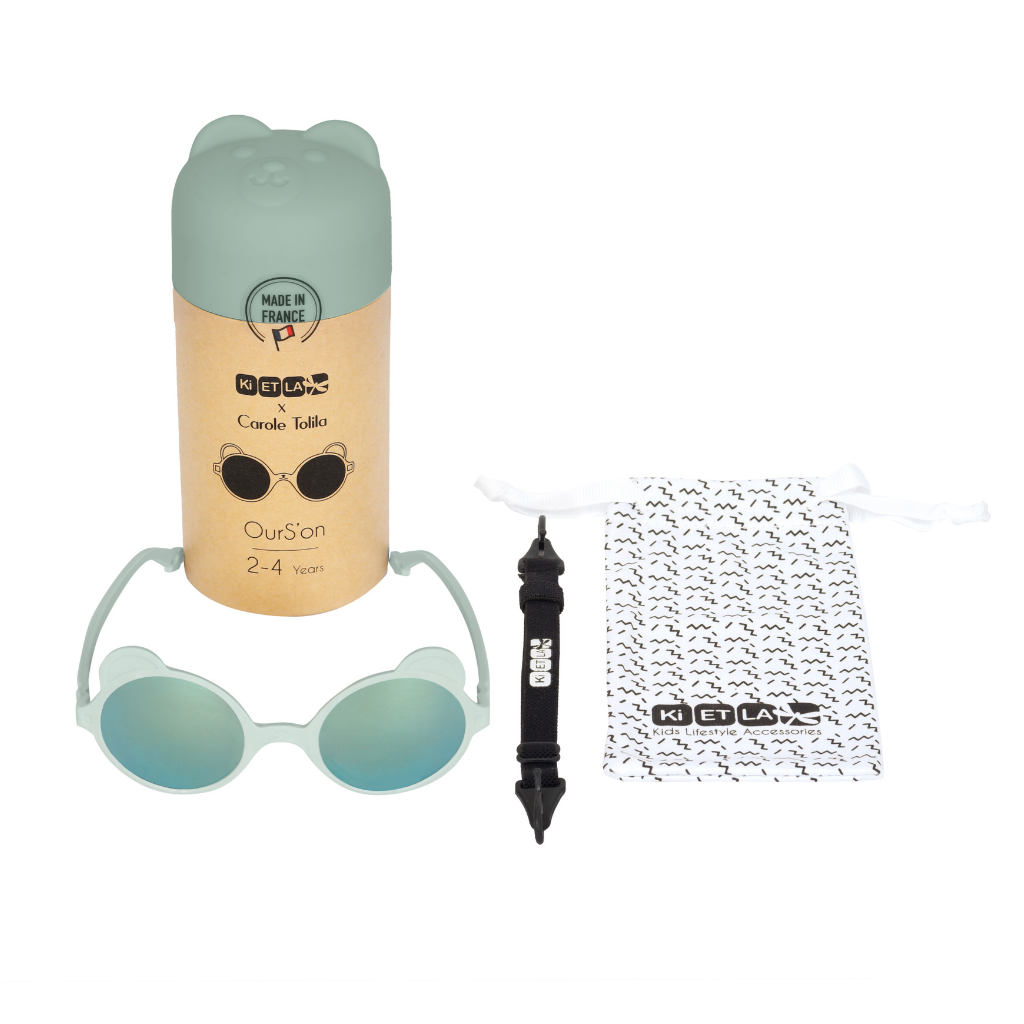 Contents of Ki et La Ourson Teddy Bear Sunglasses for Children from 1 - 4 years in almond green including box, sunglasses, strap and fabric pouch