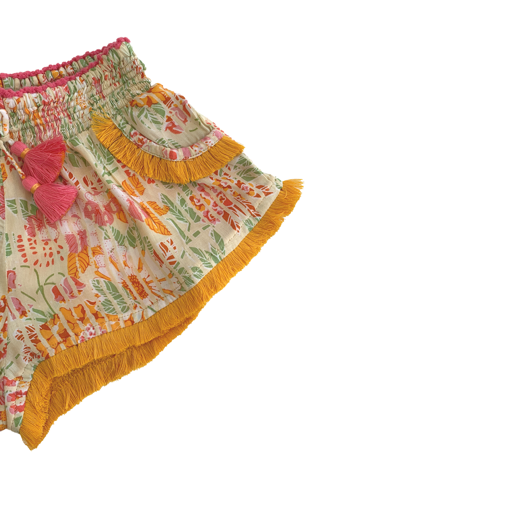 Fringe detail on Front of Poupette St Barth Children's Lulu Lace Trimmed Boxer Shorts in Yellow Marigold print